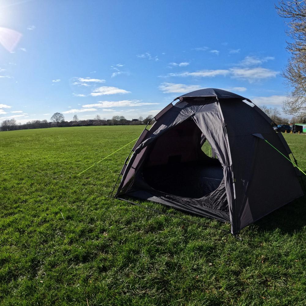 Photograph of open front LocTek Igloo MK3 Fast Pitch Tent - 3 Man Tent Khyam on sunny grass campsite with blue sky.