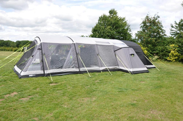 Photograph of AirTek 8 Pro Side Storage Annex Khyam for tents, on grassy campsite with trees and cloudy sky.